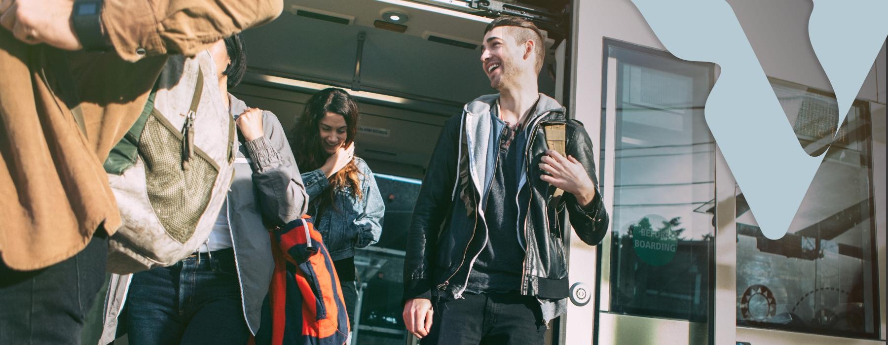 a group of people walking and exiting a transit