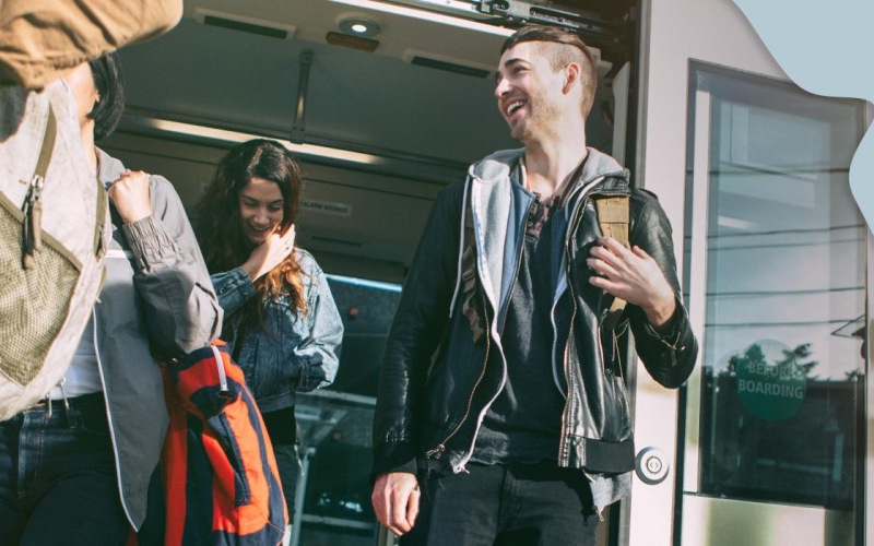 a group of people walking and exiting a transit