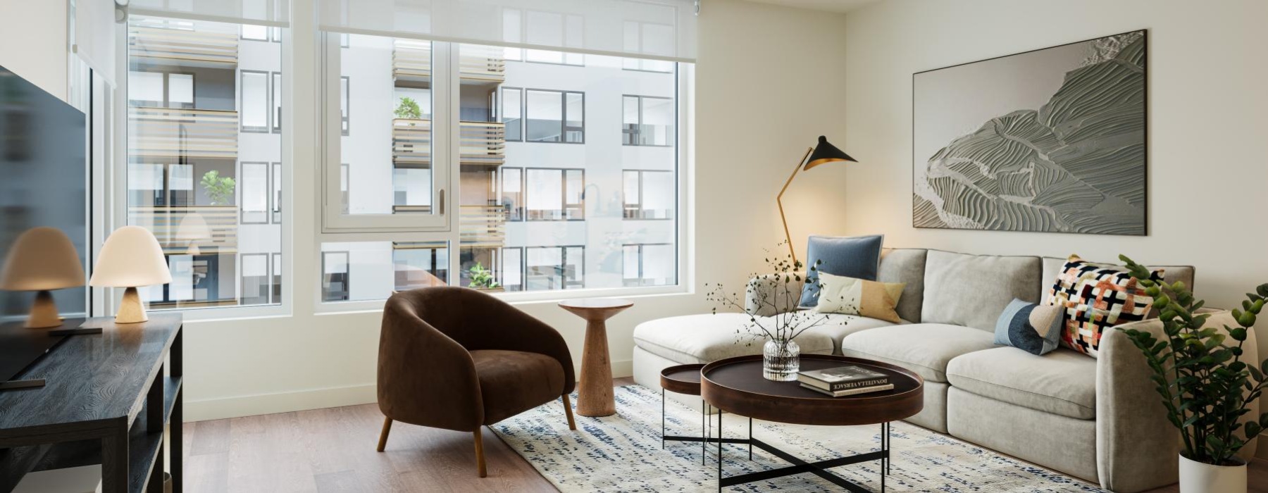 a living room with a couch and a coffee table and a large window