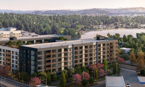 an aerial view of a large building near a lake