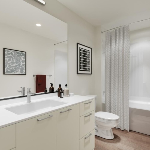 a bathroom with a tub, sink, and toilet and a laundry area