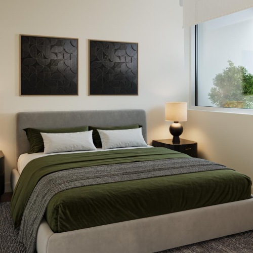 a bed in a room with a plant and large windows